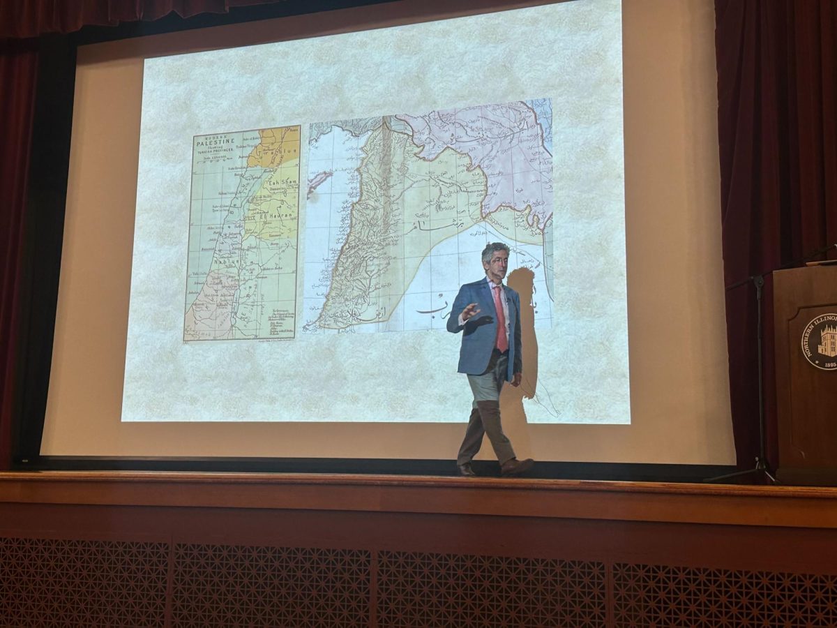 Dr. Ussama Makdisi walks across the stage during the history department's 21st annual Lincoln Lecture Thursday in Altgeld Hall. The lecture was presented by Makdisi and centered around his forthcoming book titled "Last Colonialism: From Paris to Palestine in 1919.” (Diego Martinez | Northern Star) 