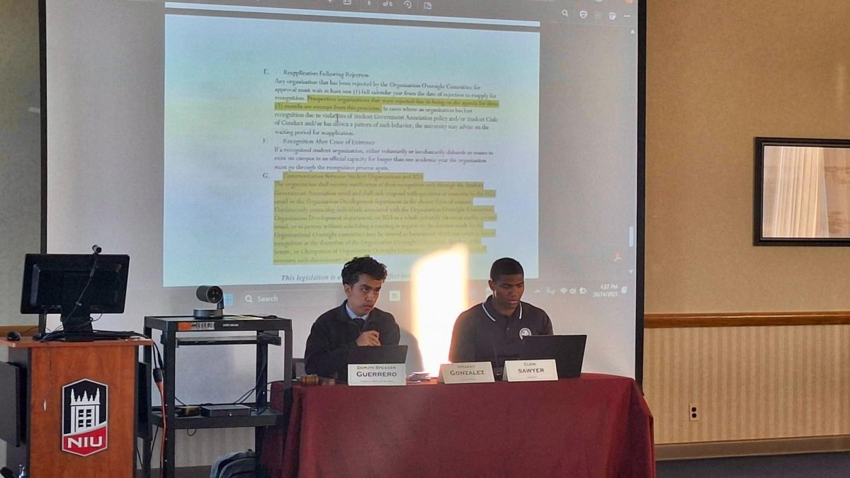 Deputy Speaker Eddie Guerrero and Senate Clerk Cameron Sawyer sit in front of the Student Government Association’s senate at their meeting Friday. The SGA passed two bills to streamline communication between SGA and student organizations at their meeting Friday. (Joseph Ndu | Northern Star)