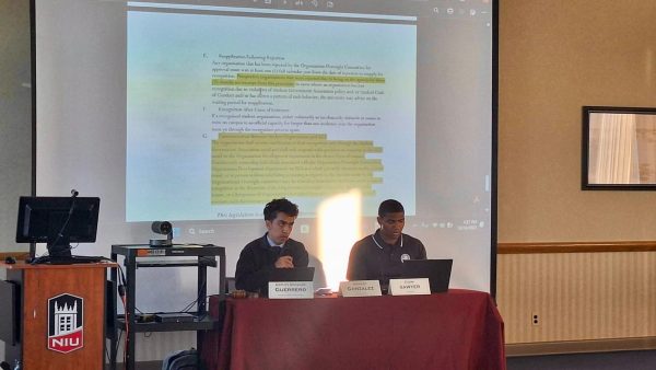 Deputy Speaker Eddie Guerrero and Senate Clerk Cameron Sawyer sit in front of the Student Government Association’s senate at their meeting Friday. The SGA passed two bills to streamline communication between SGA and student organizations at their meeting Friday. (Joseph Ndu | Northern Star) 