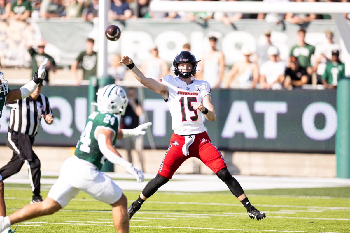 NIU redshirt sophomore quarterback Josh Holst (15) throws a pass over Ohio University graduate student linebacker Cameron Hollobaugh (24) during a football game Saturday at Peden Stadium in Athens, Ohio. Holst received his highest offensive grade of the season from Pro Football Focus after passing for a season-high two touchdowns in the 48-21 loss. (Jimmy Doles | NIU Athletics)