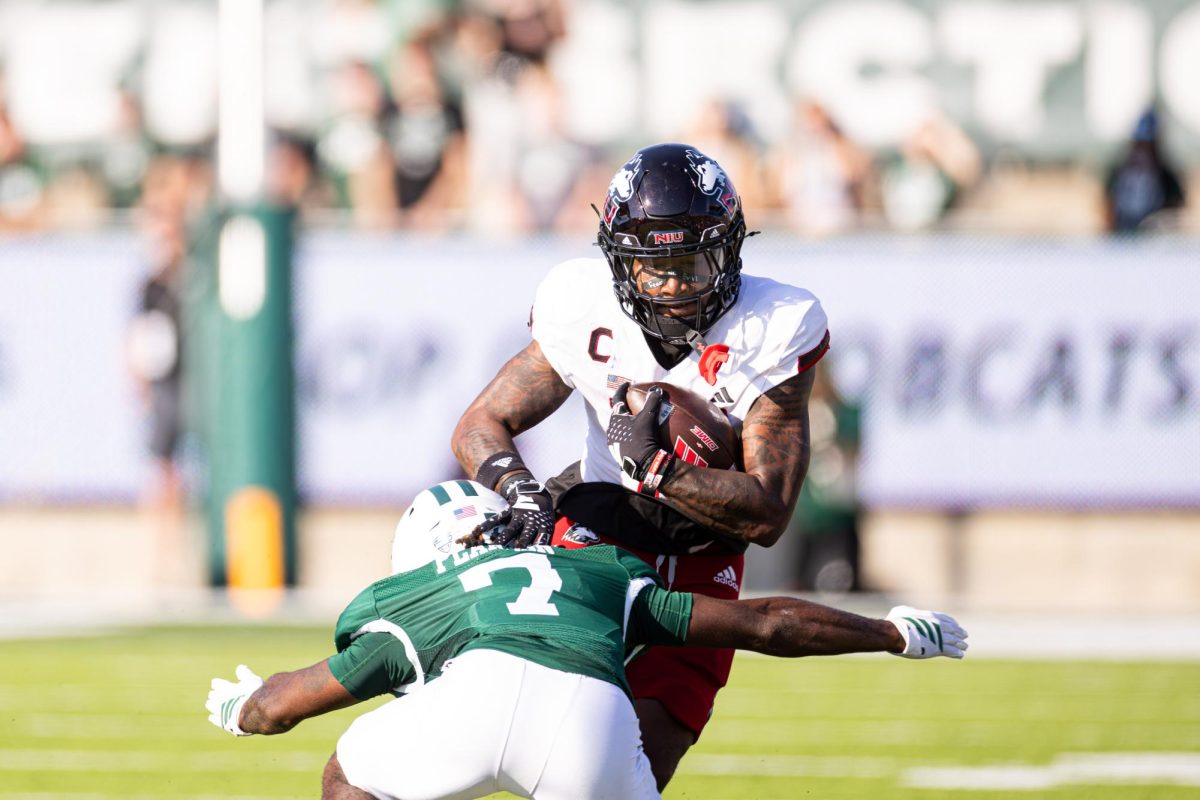 NIU junior wide receiver DeAree Rogers (6) is tackled by Ohio University graduate student cornerback Tank Pearson (7) after a 6-yard catch during the first quarter of a football game Saturday at Peden Stadium in Athens, Ohio. Rogers caught a 50-yard touchdown pass in NIU's 41-21 loss to the Bobcats. (Jimmy Doles | NIU Athletics)