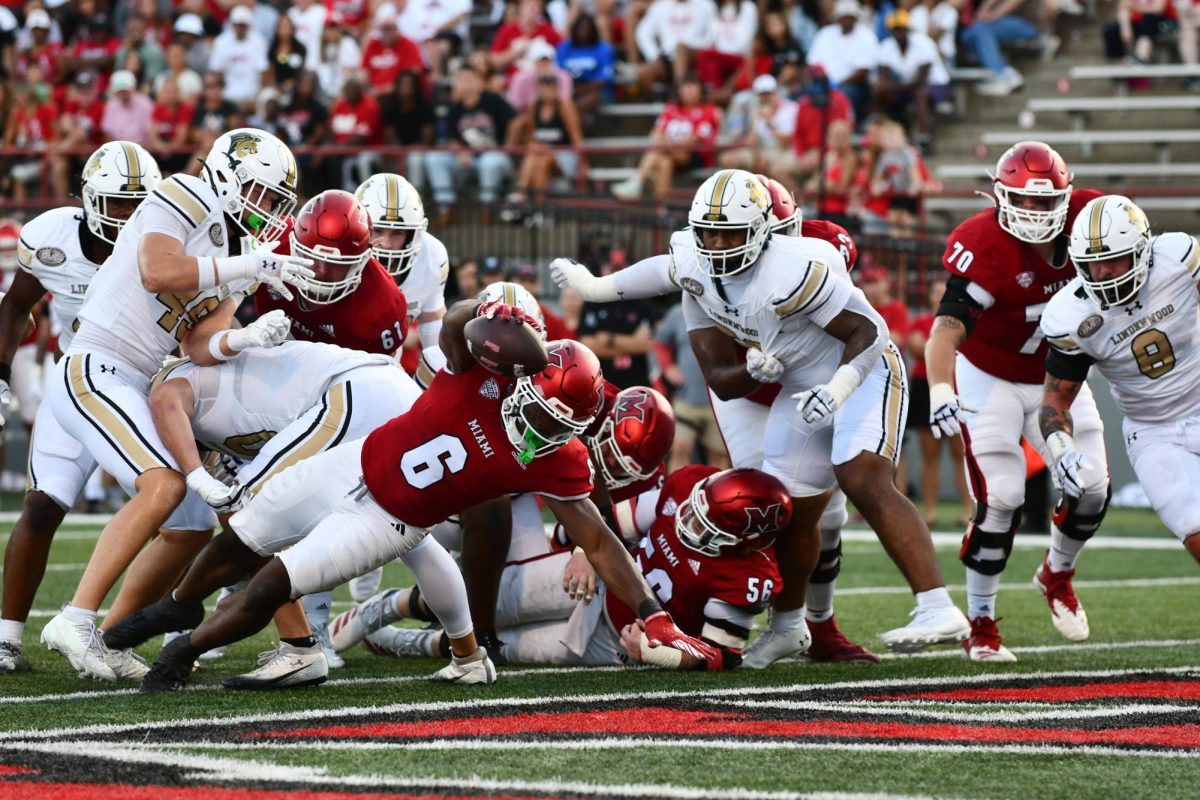 Miami University redshirt senior running back Jordan Brunson (6) reaches over the goal line for a 1-yard touchdown in the fourth quarter of the RedHawks' 38-0 victory over Lindenwood University on Saturday at Fred C. Yager Stadium in Oxford, Ohio. Miami will meet NIU on Saturday at Huskie Stadium for both teams' Mid-American Conference opener. (Kethan Babu | The Miami Student)