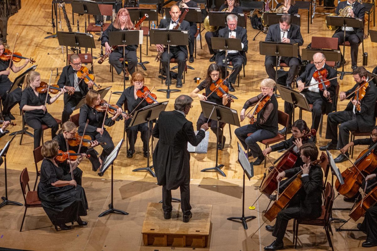 Director Linc Smelser conducts the Kishwaukee Symphony Orchestra during Wolfgang Amadeus Mozart’s “Symphony No. 25 in G Minor” on Saturday in the Boutell Memorial Concert Hall in the Music Building. The KSO was joined with soloist Teng Li, principal violist of the Chicago Symphony Orchestra, during “Viola Concerto” composed by Béla Bartók. (Totus Tuus Keely | Northern Star)