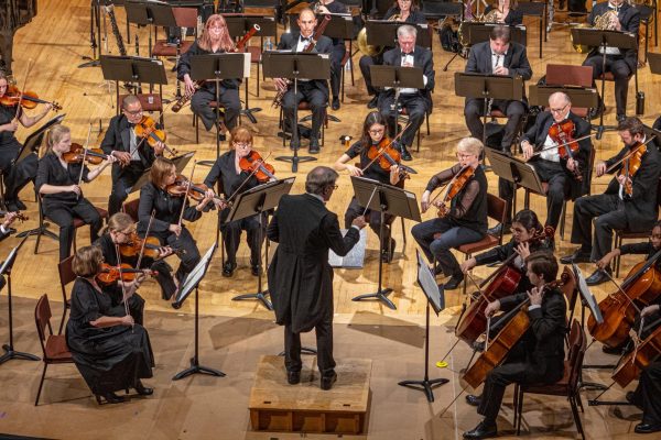Director Linc Smelser conducts the Kishwaukee Symphony Orchestra during Wolfgang Amadeus Mozart’s “Symphony No. 25 in G Minor” on Saturday in the Boutell Memorial Concert Hall in the Music Building. The KSO was joined with soloist Teng Li, principal violist of the Chicago Symphony Orchestra, during “Viola Concerto” composed by Béla Bartók. (Totus Tuus Keely | Northern Star)