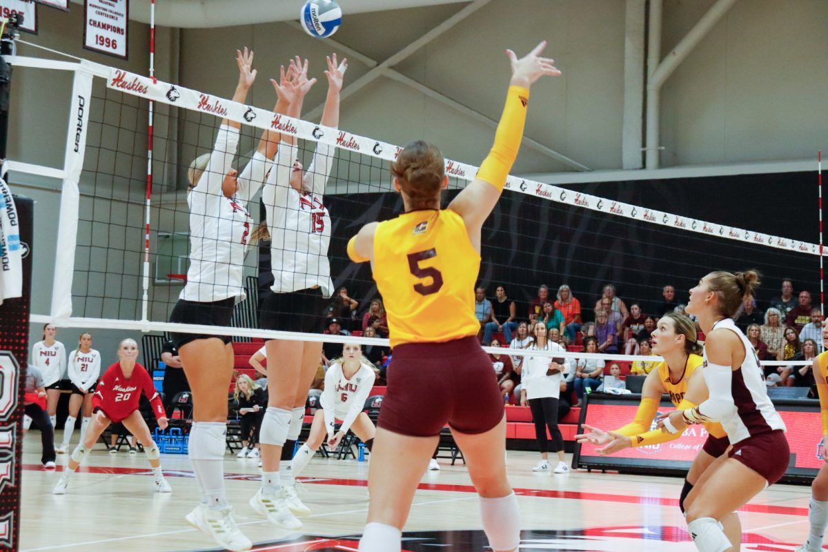 NIU volleyball sophomore setter Ella Strausberger (2) and junior middle blocker Autumn Flynn (15) jump for a block during the Huskies’ match against Central Michigan University on Sept. 25. NIU was swept for the second straight match, falling to Miami University on Friday. (Marco Alvarez | Northern Star)