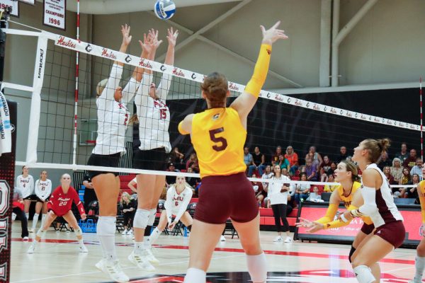 NIU volleyball sophomore setter Ella Strausberger (2) and junior middle blocker Autumn Flynn (15) jump for a block during the Huskies’ match against Central Michigan University on Sept. 25. NIU was swept for the second straight match, falling to Miami University on Friday. (Marco Alvarez | Northern Star)
