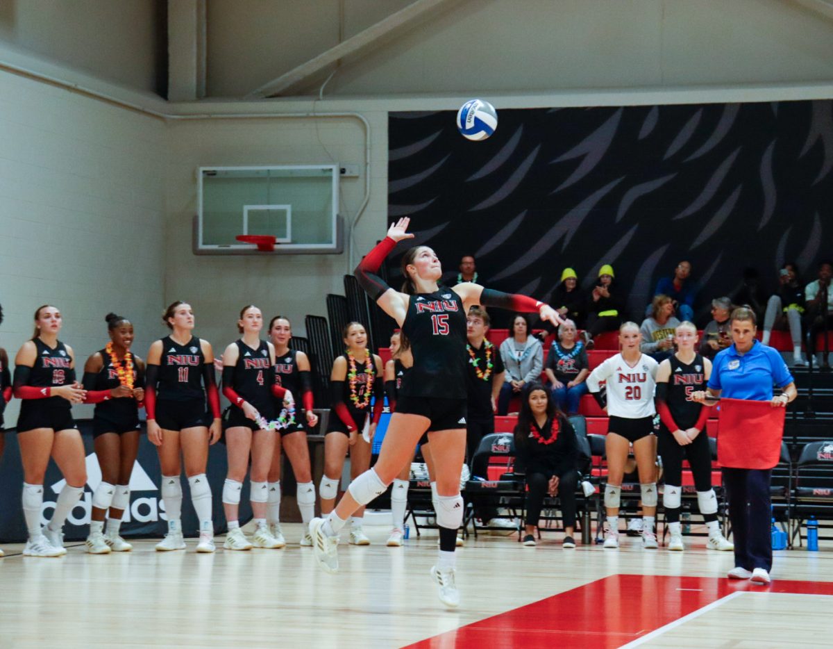 NIU volleyball junior middle blocker Autumn Flynn (15) serves the ball during the Huskies’ match against Western Michigan University on Tuesday. The Huskies swept the Broncos in a 3-0 victory, their first win against Western Michigan since 2022.  (Marco Alvarez | Northern Star)
