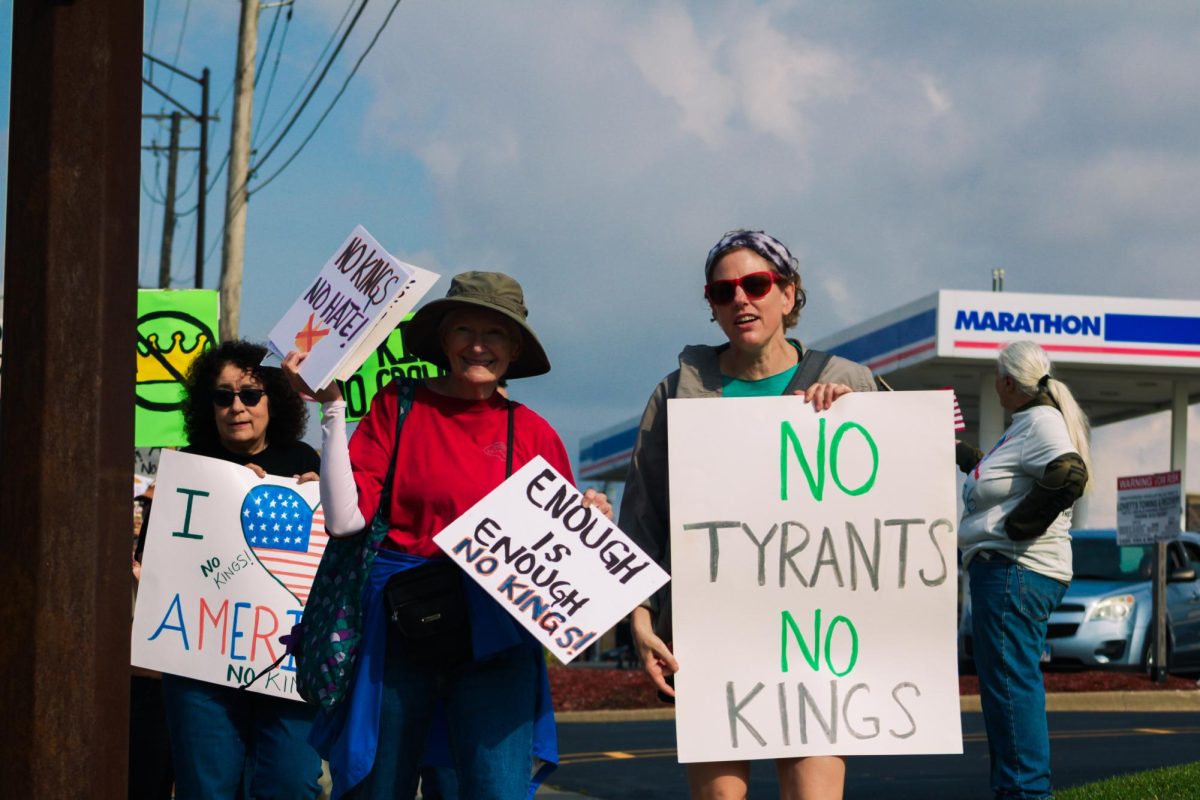A group of protesters march southbound alongside Illinois Route 23 on Saturday during the No Kings protest. Protesters began to march around 1 p.m. and started at the intersection of East Dresser Road and Illinois Route 23 to the intersection at Greenwood Acres Drive and back. (Ethan Rodriguez | Northern Star)