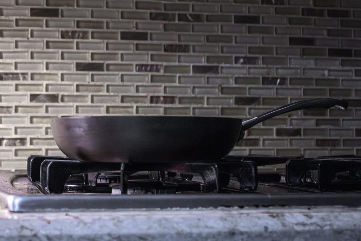 A photo pictures a non-stick pan sitting on a stove. Opinion Columnist Lucy Atkinson believes people should be aware of objects with PFAs or "Forever Chemicals" as they pose a risk to our health and environment. (Ethan Rodriguez | Northern Star)