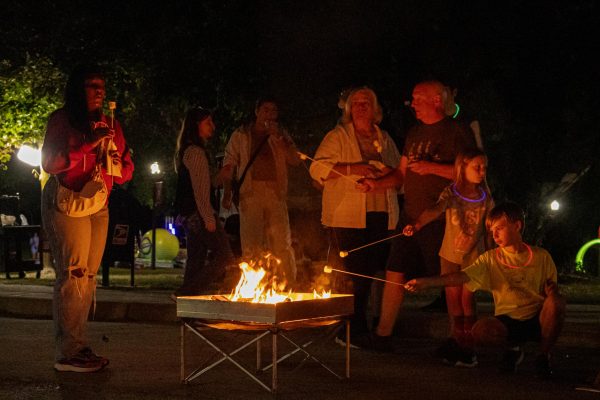 NIU Students and DeKalb residents huddle around a fire while making s’mores during the
Huskies S’mores N’ more event hosted by Student Involvement on Friday outside in MLK
Commons. The event was from 7 p.m. to 9 p.m. and included karaoke, s’mores, hot chocolate,
Mission III, minigolf and more activities for students and residents. (Totus Tuus Keely | Northern
Star)