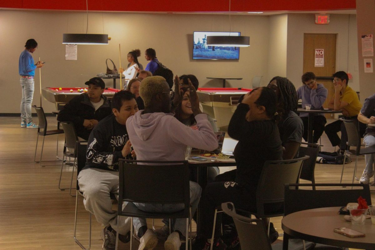 Senior economics major Fallou Dia (left) and senior computer science major Abril Morales celebrate with a high five during Huskie Trivia Night on Sept. 9 in the Huskie Den. The Trivia Night will be held again from 7 p.m. to 8 p.m. on Tuesday in the lower level of the Huskie Den. (Northern Star File Photo)