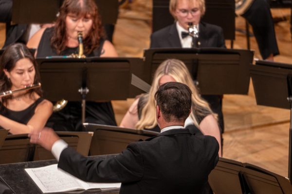 Tom Bough, director of the Wind Ensemble, conducts through “Allerseelen” composed by Richard Strauss and arranged by Albert Oliver Davis during the NIU Wind Ensemble’s performance on Tuesday in the Boutell Memorial Concert Hall in the Music Building. “Allerseelen” was originally composed for solo voice and piano but was arranged for a wind band by Davis. (Totus Tuus Keely | Northern Star)