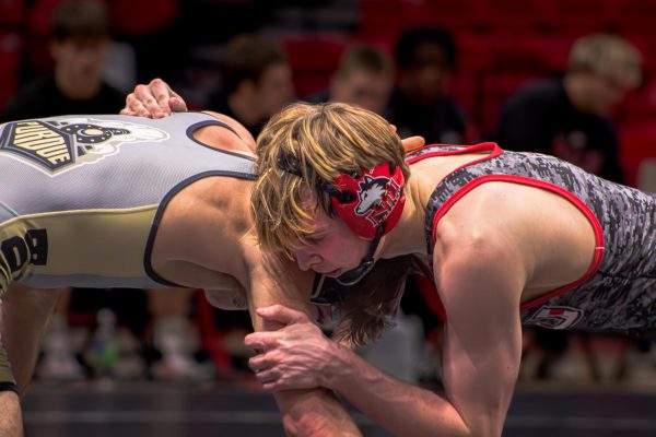 NIU redshirt sophomore wrestler Jacob Brya locks shoulder to shoulder with Purdue University redshirt freshman Cole Solomey during the 141-pound matchup in a dual meet on Jan. 12 inside the Convocation Center in DeKalb. NIU will pay a $28,000 affiliate membership fee to the Pac-12 over five years. (Northern Star file photo)