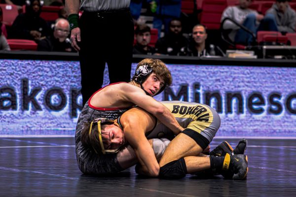 NIU redshirt junior wrestler Blake West looks up as he grapples with Purdue University redshirt senior Matt Ramos during the 125-pound matchup in a dual meet on Jan. 12 inside the Convocation Center in DeKalb. NIU will join the Pac-12 as an affiliate member for wrestling in 2026. (Northern Star file photo)