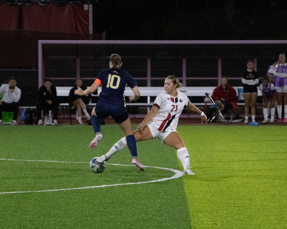 NIU women’s soccer sophomore midfielder Lauren Mrugala (21) reaches for the ball in the Huskies’s match against the University of Akron on Sept. 25. NIU earned its first Mid-American Conference win in a 1-0 victory over Central Michigan University on Thursday. (Alexia Beck | Northern Star)