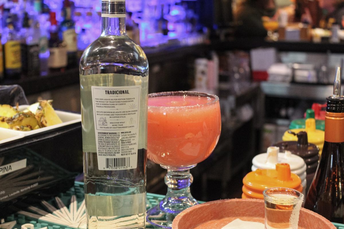A bottle of Jose Cuervo Silver Tequila stands next to a bright red alcoholic drink near the bar at El Jimador, located at 260 E. Lincoln Highway. Opinion Columnist Byrdie Seda argues the rights you get at 21 should also apply to when you turn 18. (Northern Star File Photo)