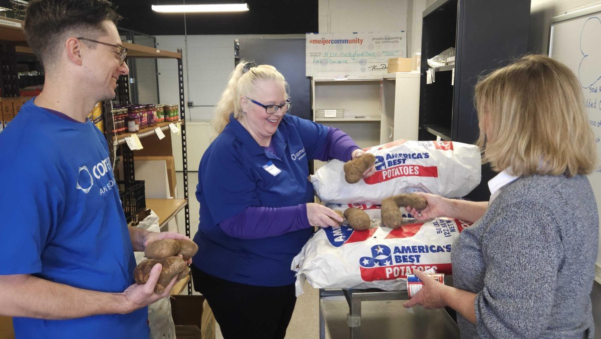 Tom Tumminaro (from left), Suzanna Strangmeier and Jeanne Baxter unload several bags of potatoes. The Huskie Food Pantry has been operating at NIU for the past 10 years and helps students obtain food and connect with their community. (Northern Star File Photo)