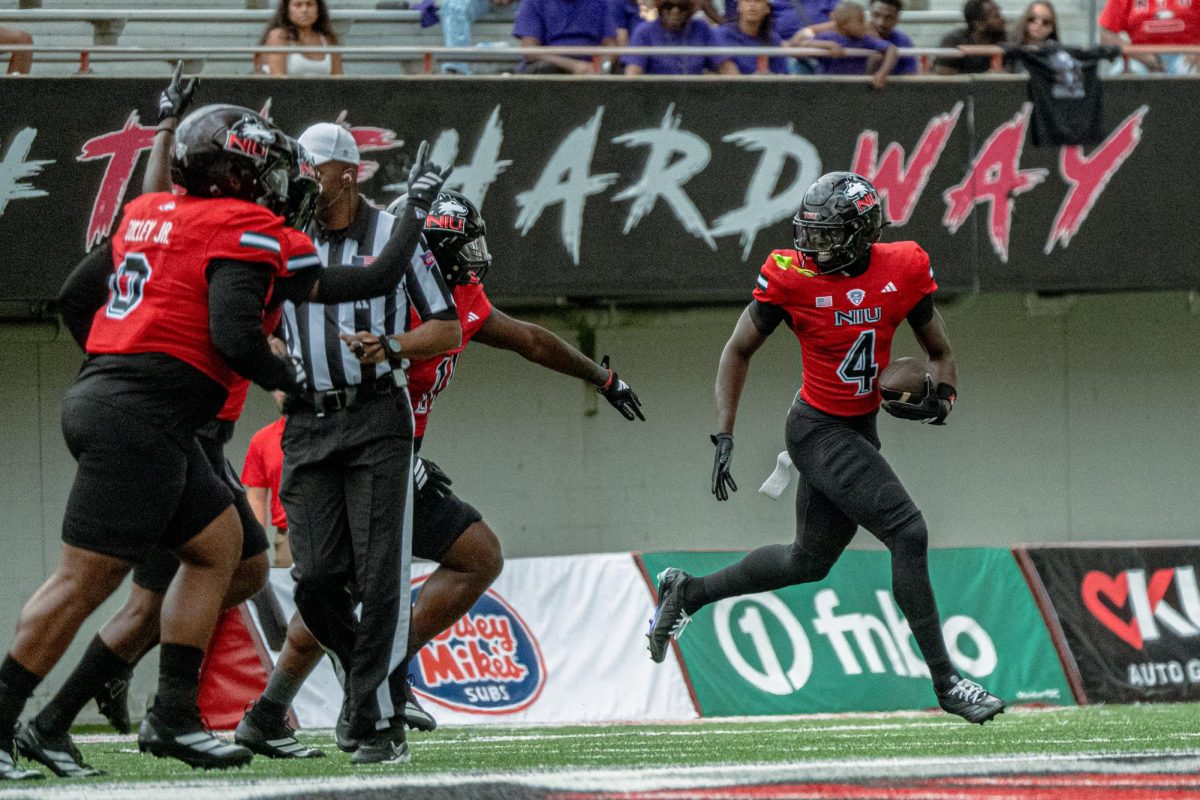 NIU redshirt senior safety Muhammed Jammeh (4) celebrates his interception during the first quarter of a football game against College of the Holy Cross on Aug. 30 at Huskie Stadium in DeKalb. The Huskies will close out their regular season with back-to-back home games, starting with a Tuesday night matchup against Western Michigan University. (Northern Star file photo)