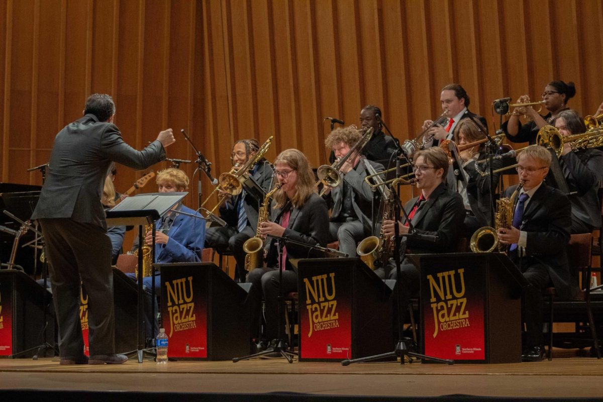 Rodrigo Villanueva, Professor of Jazz Studies, leans lower as the NIU Jazz Ensemble’s volume decreases during their performance on Oct. 9, 2024. In this Weekly Writeup, you can find events such as a performance by the NIU Jazz Ensemble, a World Music Fall series and more. (Northern Star File Photo)