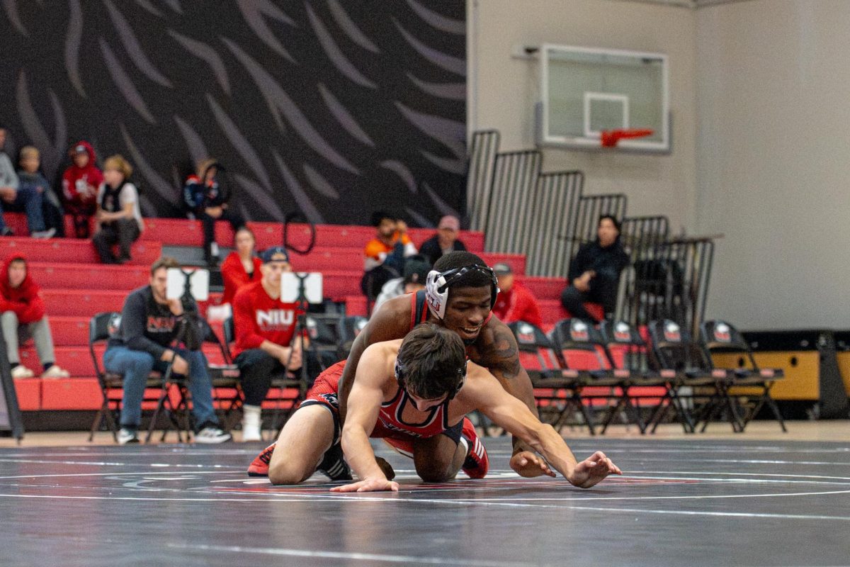 NIU wrestling redshirt junior Markel Baker, top, battles with redshirt freshman Calvin Werden during the Red-Black Dual on Oct. 30. Baker was named the MAC West Wrestler of the Week for the second consecutive week on Nov. 18 after going undefeated at the Boilermaker Duals on Saturday. (Totus Tuus Keely | Northern Star)