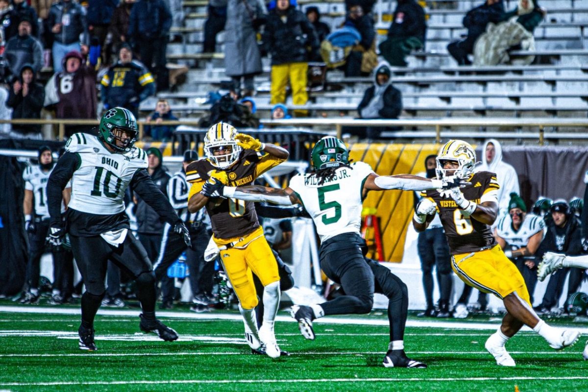Western Michigan University graduate student wide receiver Tailique Williams (0) dodges an attempted tackle by Ohio University senior safety Adonis Williams Jr. (0) during a 71-yard catch-and-run in the fourth quarter of a Mid-American Conference football game on Nov. 11 at Waldo Stadium in Kalamazoo, Michigan. Western Michigan will face NIU on Tuesday night in DeKalb, looking to snap a three-game losing streak in the all-time series between the schools. (Riley Ashby | Western Herald)