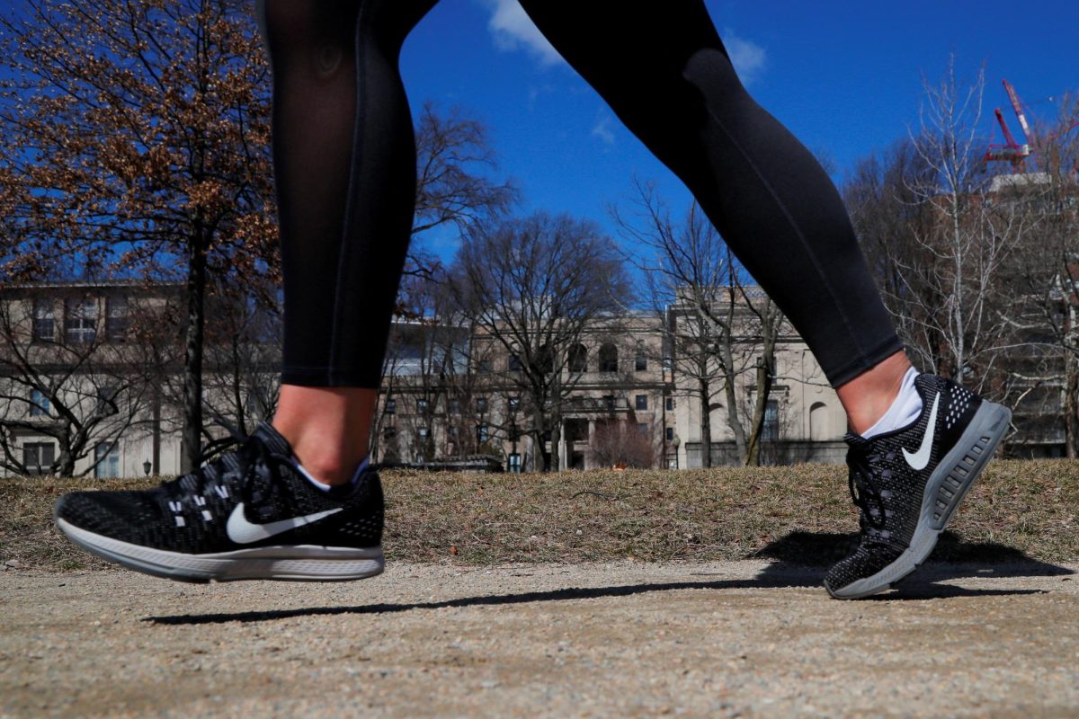 A person jogs while wearing Nike shoes runs along the Charles River in Cambridge, Massachusetts. Opinion Editor Gabriel Santos argues people should rethink New Year's traditions and not set such lofty goals. (Brian Snyder | REUTERS)