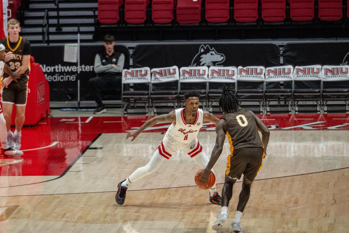 NIU redshirt freshman guard Isaiah Washington guards Quincy University senior guard Camren Kincaid during the Huskies’ exhibition match against Quincy on Oct. 28. NIU fell to Bradley University in an 84-55 loss on Friday.   (Totus Tuus Keely | Northern Star) 

