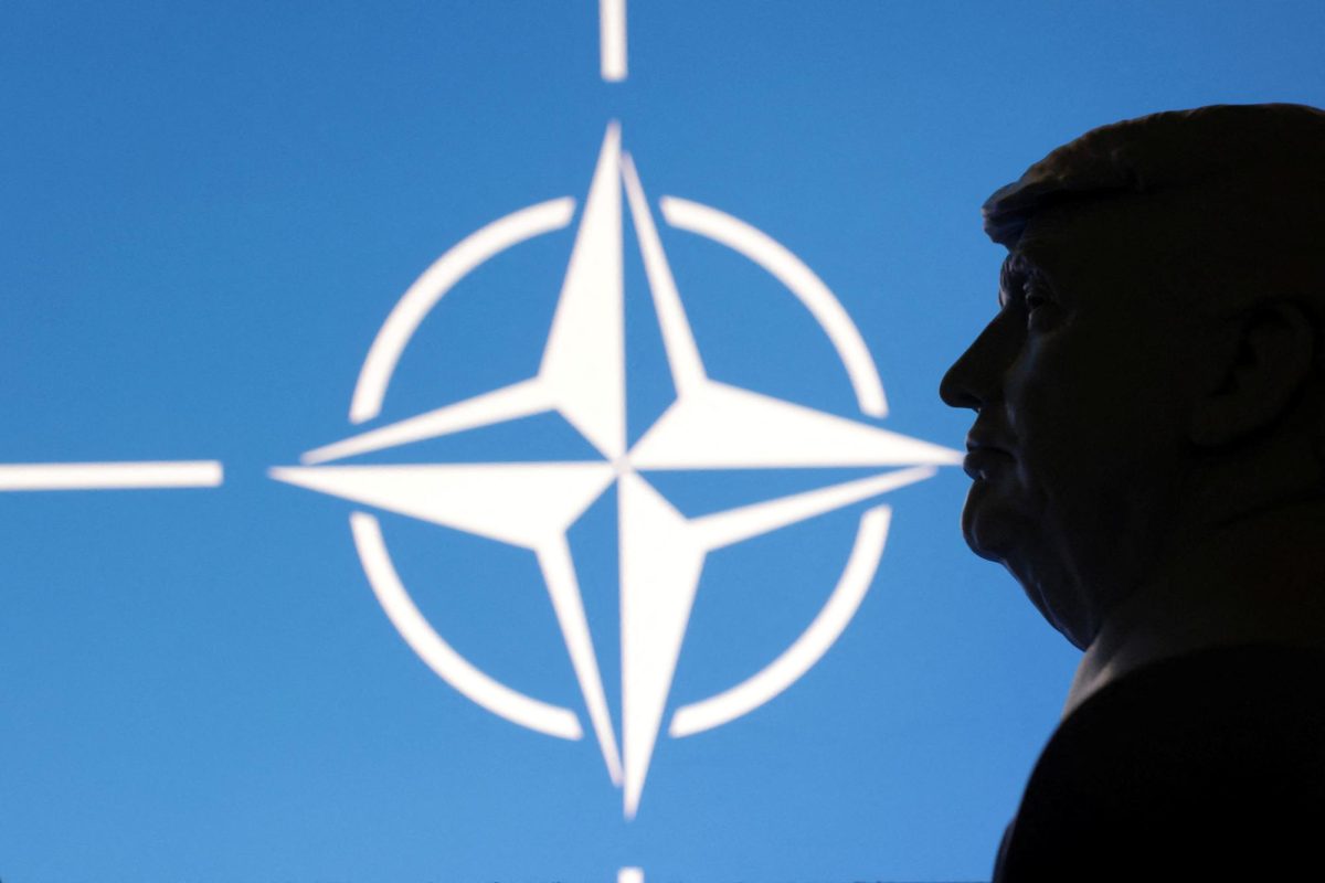 A 3D-printed miniature model of U.S. President Donald Trump with the NATO logo in the background is seen in an illustration from April 23. Opinion Columnist Ethan Ernst believes Trump's continued antagonizing of NATO and allies has negative effects for both sides. (REUTERS | Dado Ruvic)