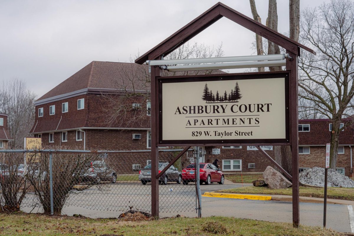 An Ashbury Court Apartments sign sits in front of the apartment complex at 829 W. Taylor St. Two men were injured on Thursday in a stabbing at the Ashbury Court Apartments. (Totus Tuus Keely | Northern Star)