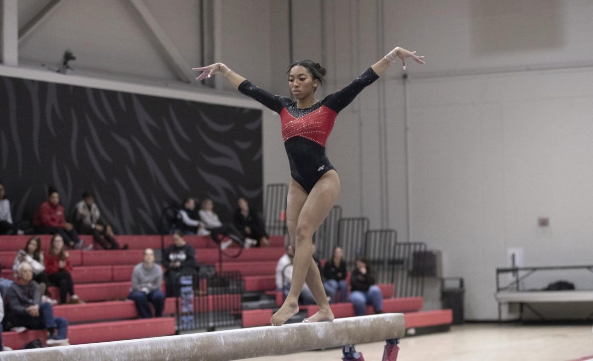 
NIU sophomore Drake White performs her balance beam routine during the Red-Black Exhibition on Dec. 19. NIU fell to Kent State University in their first head-to-head match of the season, with a team score of 191.675. (Courtesy of NIU Athletics) 