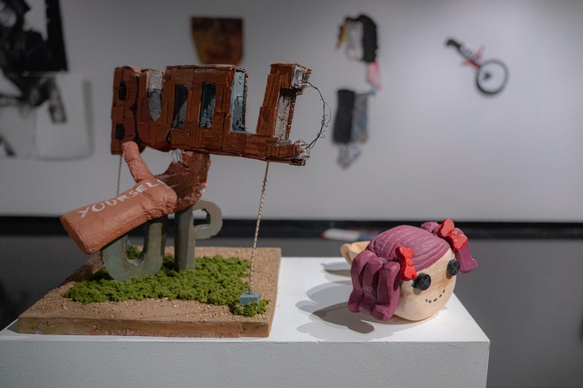 A sculpture reading “Build Yourself Up” (left) made by sophomore art and design education major Eric Perez and a sculpture of a doll’s head created by junior design and media arts major Jestrel Anzu, both for the 3D foundations class, are displayed on Tuesday in the Jack Olson Gallery in Jack Arends Hall. The gallery is open from 10 a.m. to 4 p.m. Mondays through Thursdays until Feb. 13. (Totus Tuus Keely | Northern Star)