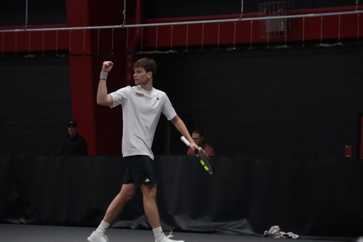 NIU men’s tennis senior Federico Scotuzzi celebrates after a comeback win during the Huskies’ match against Indiana University Indianapolis on Friday in the Chick Evans Field House. The Huskies earned their first win of the spring season by defeating the Jaguars 5-2. (Sanaa Scott | Northern Star)