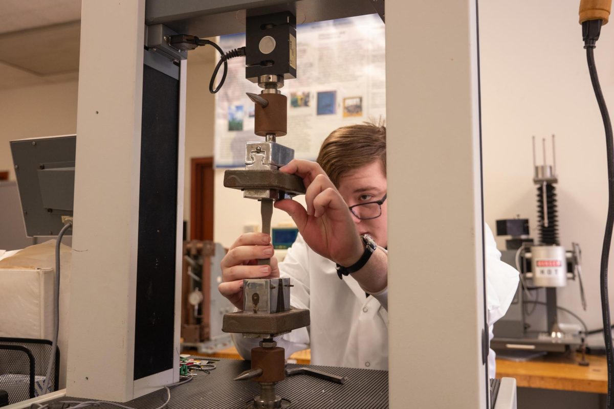 Ryan Mueller, mechanical engineering graduate student and senior graduate assistant, performs a tensile stress test on a 15% hemp and 85% PLA and BPAP material in the Bioplastics Lab led by Associate Professor Mahdi Vaezi in Still Gym, Room 212. NIU offers many resources and labs for undergraduate and graduate students to participate in. (Totus Tuus Keely | Northern Star)