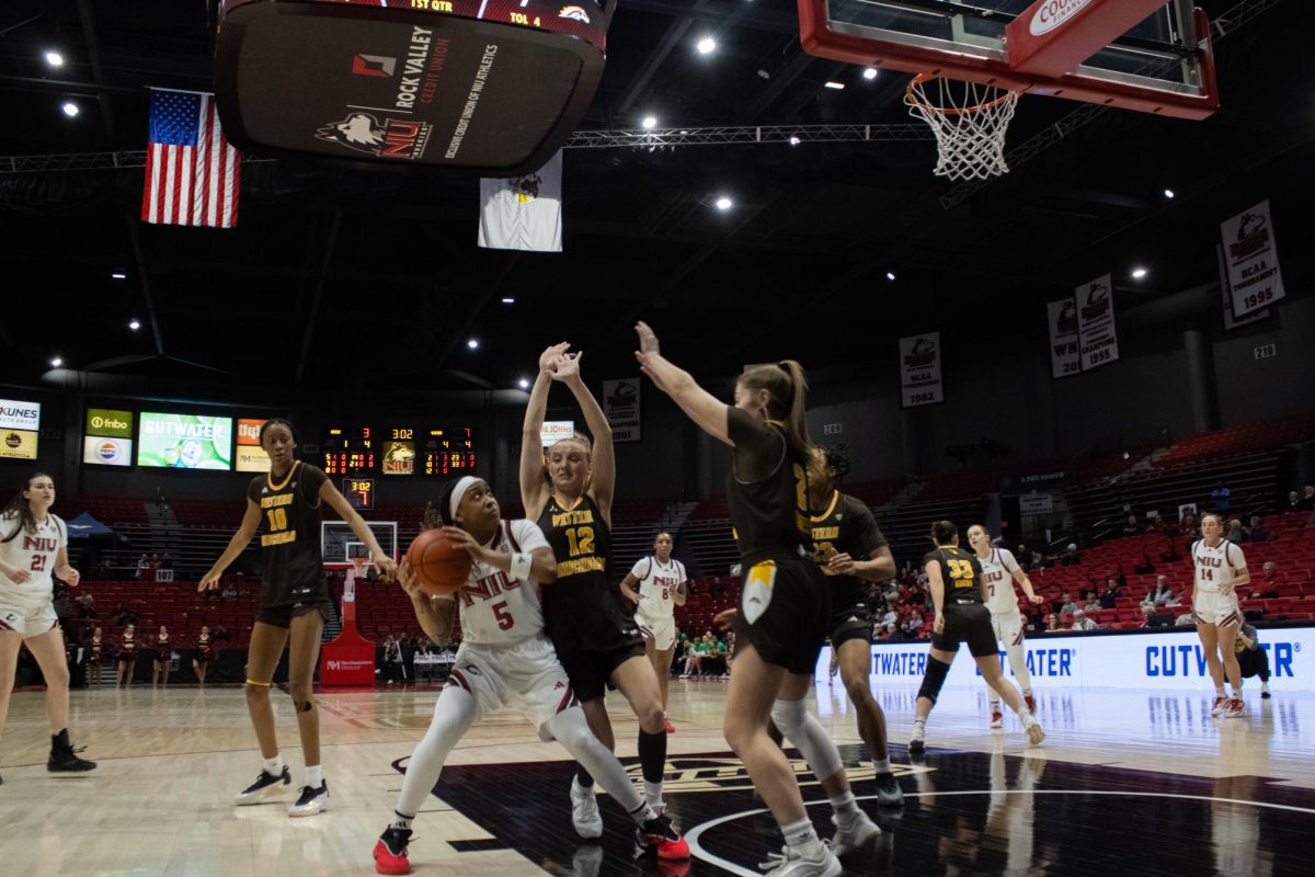 NIU women’s basketball freshman guard Sa’Mahn Johnson (5) prepares to throw the ball while guarded by Western Michigan University players on Wednesday at the Convocation Center. NIU sits at 2-6 in the Mid-American Conference after their loss to Eastern Michigan University on Saturday. (Ethan Rodriguez | Northern Star)