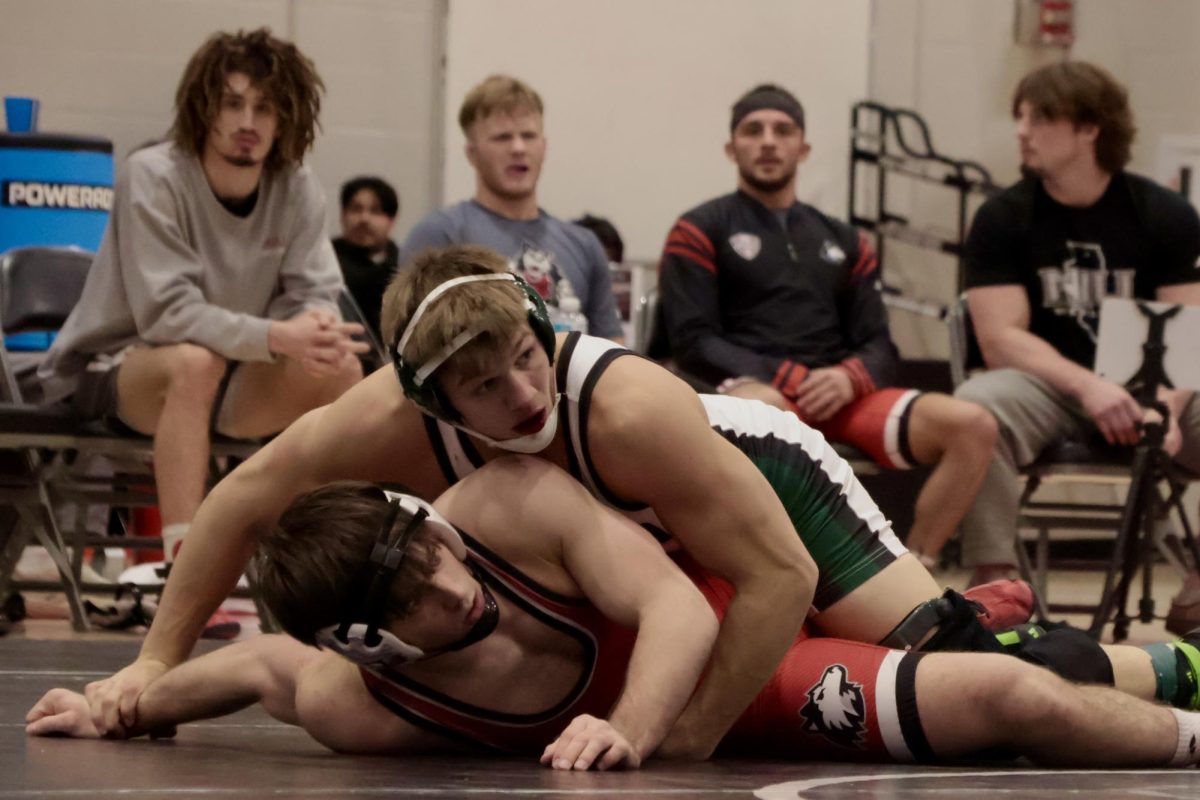 NIU wrestling redshirt junior Tommy Bennett is held down by Ohio University redshirt senior Garrett Thompson during the 174-pound duel on Friday at Victor E. Court in the Convocation Center. Bennett claimed the 174-pound match 6-5 by decision. (Sofia Howell | Northern Star) 