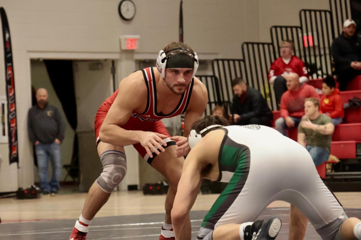 NIU wrestling redshirt sophomore Collin Arch eyes his Ohio University redshirt junior opponent Paul Woo during the 149-pound match on Friday in Victor E. Court in the Convocation Center. The next home NIU Wrestling match will be at 7 p.m. Feb. 20 for Beauty and the Beast and Senior Night against Southern Illinois University Edwardsville. (Sofia Howell | Northern Star)