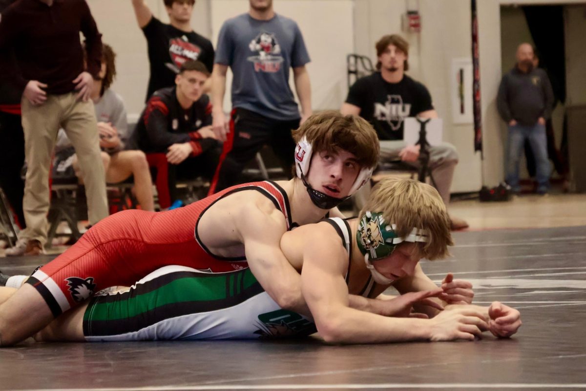 NIU wrestling redshirt senior Blake West pins Ohio University freshman Brayden Teunissen on Friday in Victor E. Court in the Convocation Center. NIU hosted the Bobcats at 6 p.m. on Friday as the second match of a double dual against Ohio and Kent State University. (Sofia Howell | Northern Star)