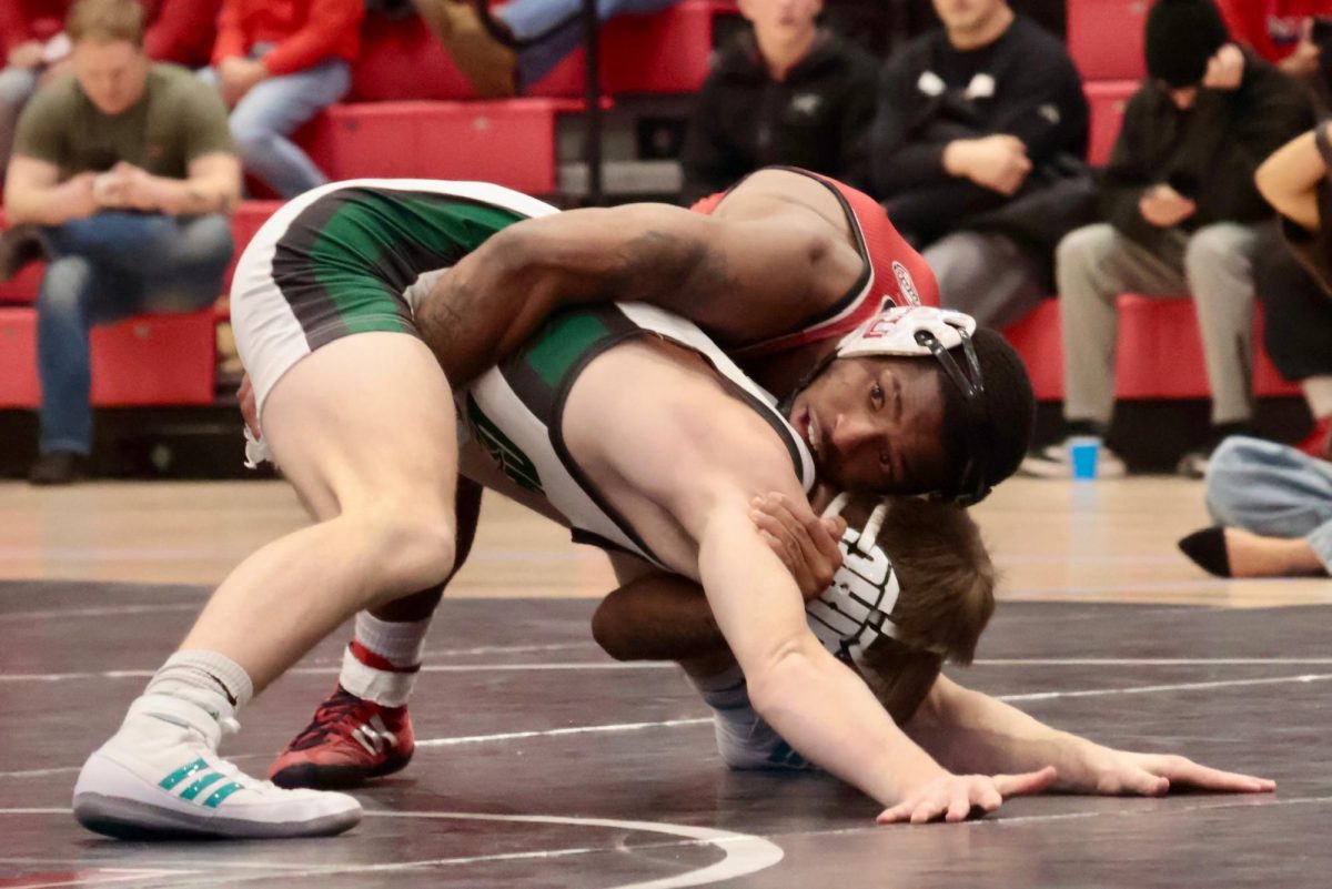 NIU wrestling redshirt junior Markel Baker battles for control with Ohio University junior Ryan Meek. Baker has a career record of 50-22 since joining the NIU wrestling team in 2022. (Sofia Howell | Northern Star)