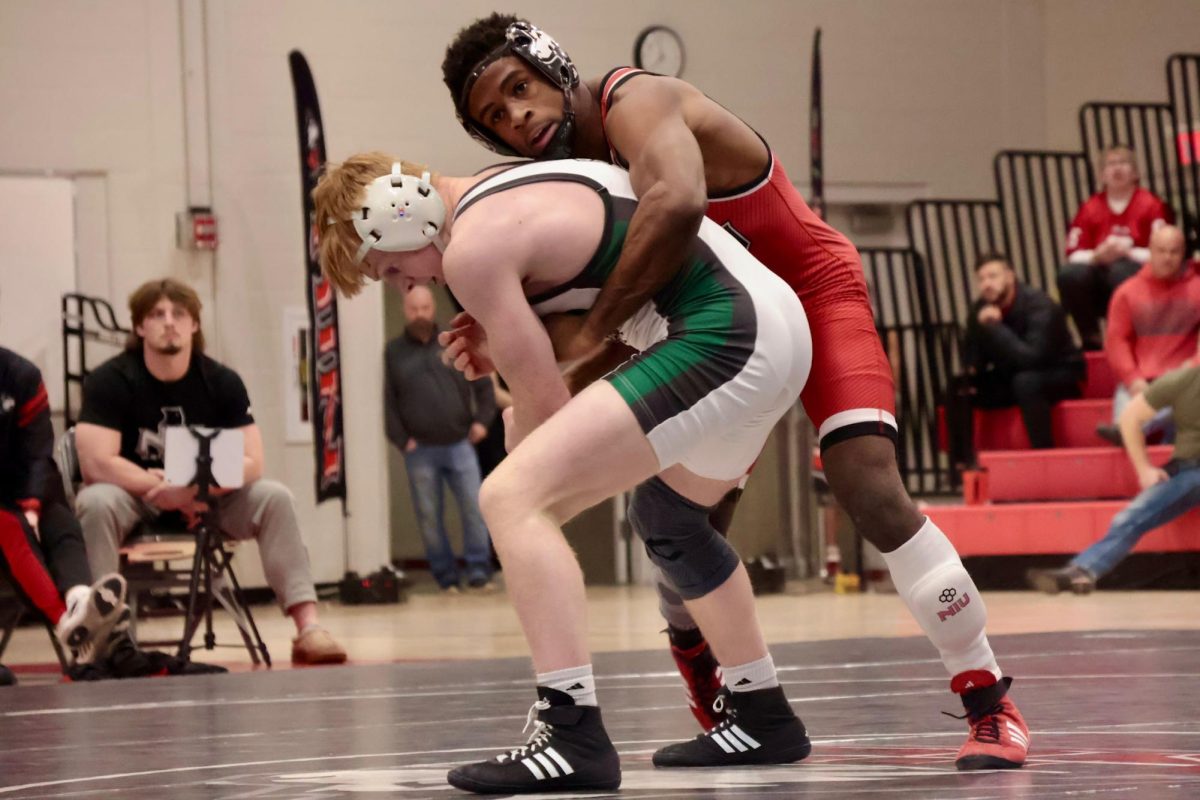 Freshman Charles Curtis grapples Ohio University sophomore Kolten Barker on Friday at Victor E. Court in the Convocation Center. Curtis defeated Barker 4-2 by decision. (Sofia Howell | Northern Star)
