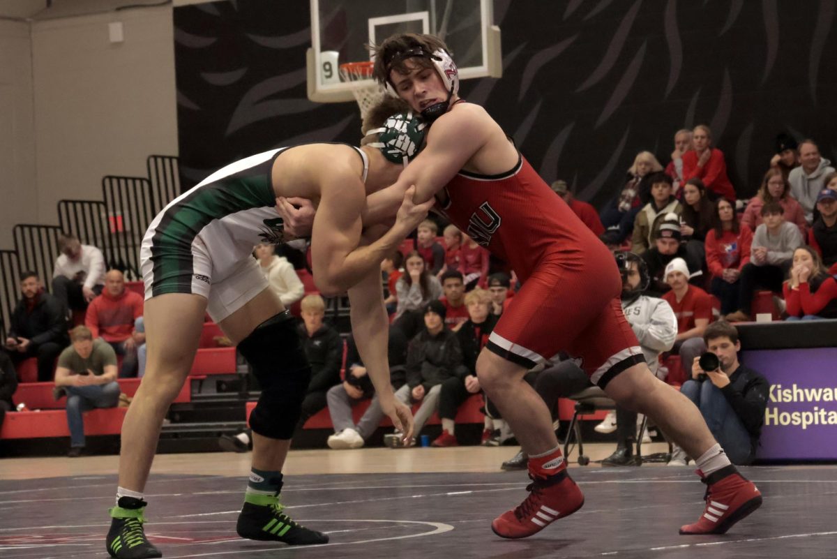 NIU wrestling redshirt junior Tommy Bennett battles against Ohio University redshirt senior Garrett Thompson on Friday at Victor E. Court in the Convocation Center. Bennett was named the Co-Wrestler of the Week by the Mid-American Conference on Monday. (Sofia Howell | Northern Star)