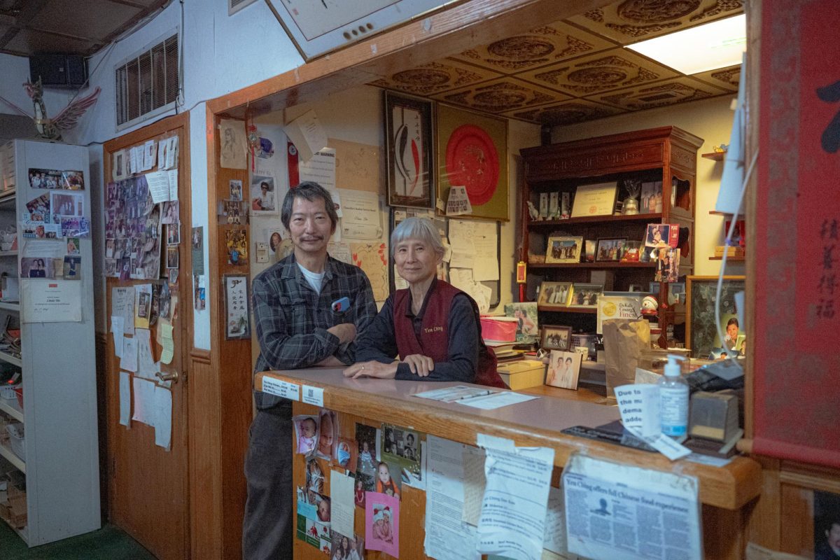 Owners John Yin (left) and Marilyn Yin pose for a portrait on Tuesday at the front counter of Yen Ching, 810 W. Lincoln Highway. Yen Ching is closing this December after serving and building relationships with the DeKalb community for over 40 years. (Totus Tuus Keely | Northern Star)