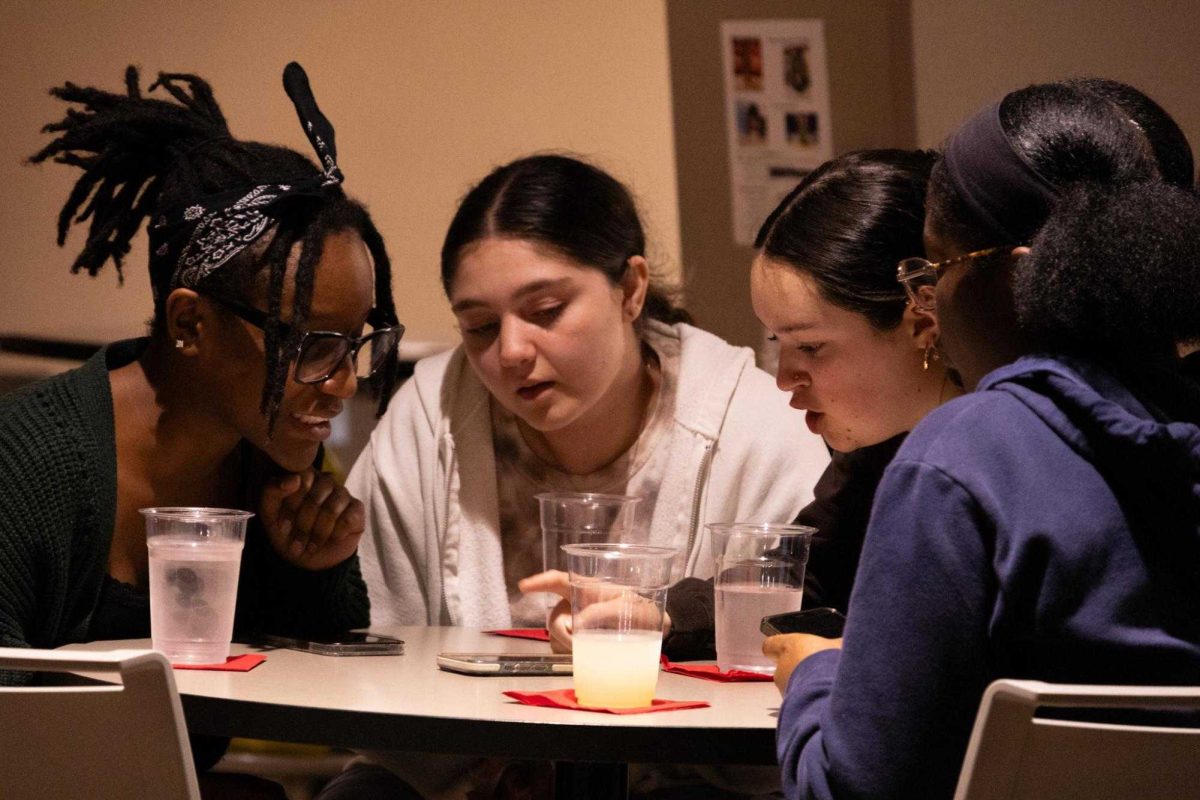 First-year business major Kyla Grubbs (from left), and sophomores Kelly Wehner, a health sciences major, Adriana Jenkins, a human development and family sciences major, and Madison Grubbs, a sociology and criminology major, review their answer to a question during Huskie Den Trivia Night on Oct. 14. The next trivia night will be from 7 p.m. to 8:30 p.m. on Tuesday in the Huskie Den of the Holmes Student Center. (Northern Star File Photo)