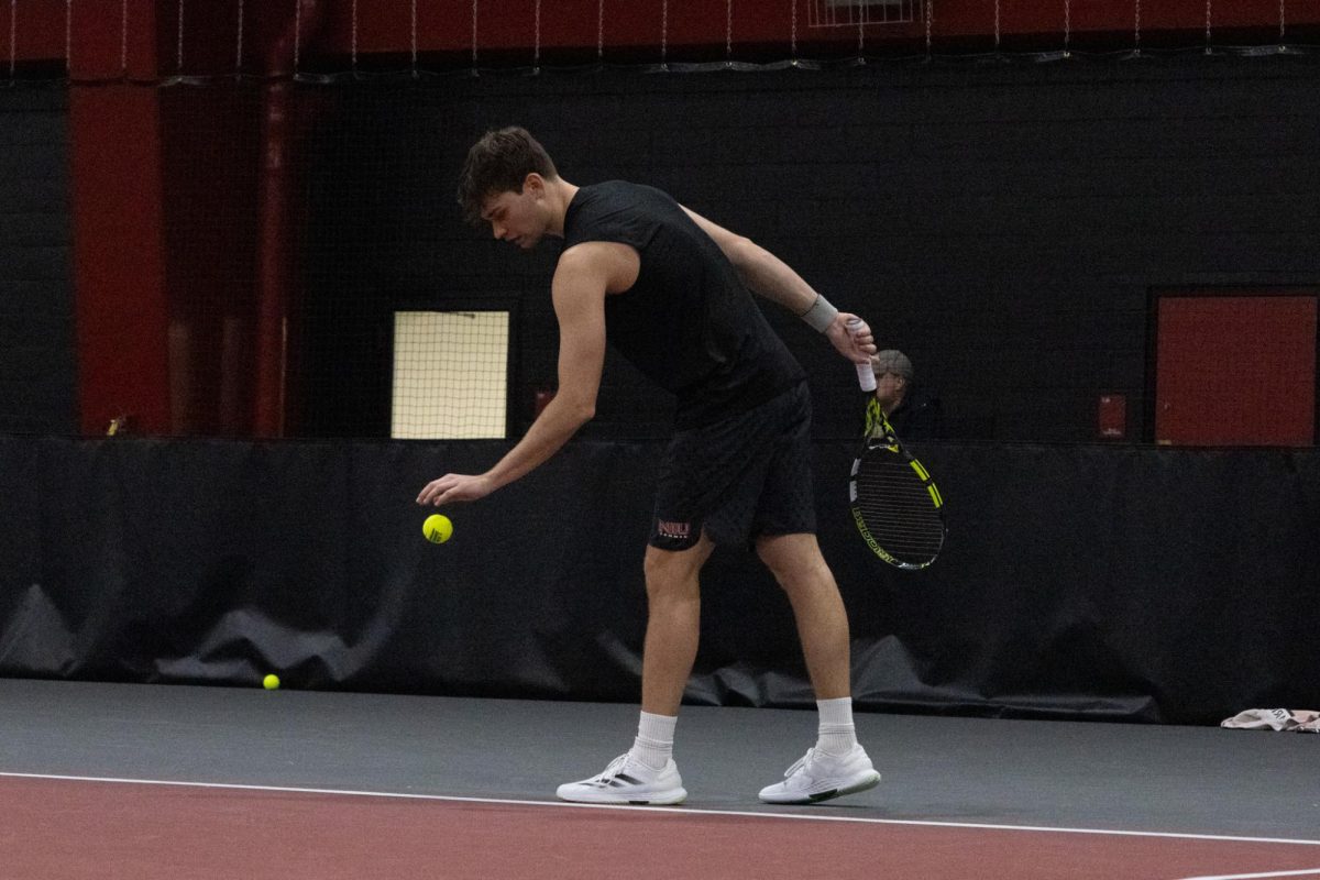 NIU men’s tennis senior Federico Scotuzzi prepares to serve in his singles match against Xavier University freshman Bode Campbell on Jan. 31. NIU defeated Roosevelt University in a 6-1 match on Saturday, improving to 3-1 on the season. (Northern Star file photo) 
