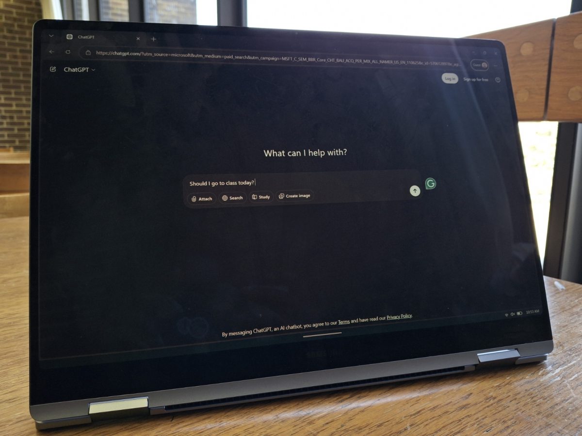 A laptop displays the ChatGPT homepage with the prompt “Should I go to class today?” typed into the chat bar. Lifestyle Writer Emily Beebe let ChatGPT control her actions for a day. (Sanaa Scott | Northern Star)