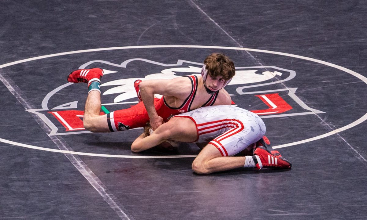 NIU wrestling redshirt senior Blake West takes on Southern Illinois University Edwardsville sophomore Drew Davis during the Beauty and the Beast meet on Friday inside the Convocation Center. West tied the NIU record for career wins on Friday, notching his 116th victory as the Huskies lost a 16-15 bout. (Eric McGill | Northern Star)