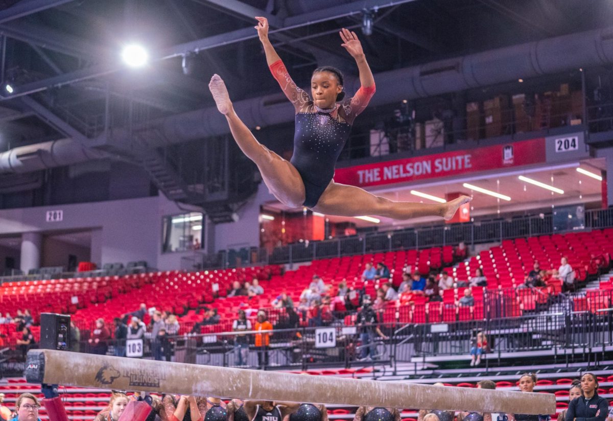 NIU women’s gymnastics junior Mikayla Brown jumps during her beam routine during the Beauty and the Beast meet on Friday inside the Convocation Center. The Huskies fell in a narrow 192.700-192.650 meet to Illinois State University on Monday. (Northern Star file photo)