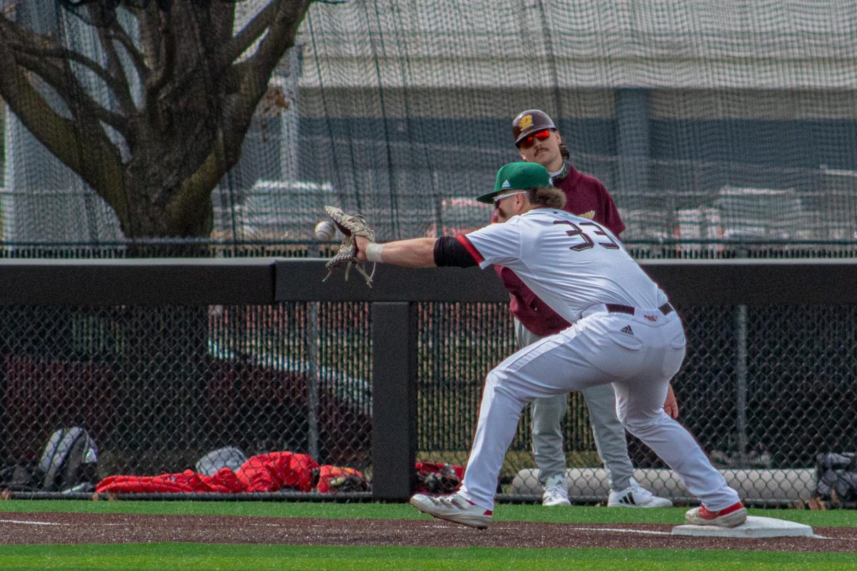 NIU baseball graduate student first baseman Gavin Baldwin (33) catches a throw at first during the Huskies’ game against Central Michigan University on March 21. The Huskies opened their season with a 10-2 win over North Carolina A&T State University on Friday. (Northern Star file photo) 
