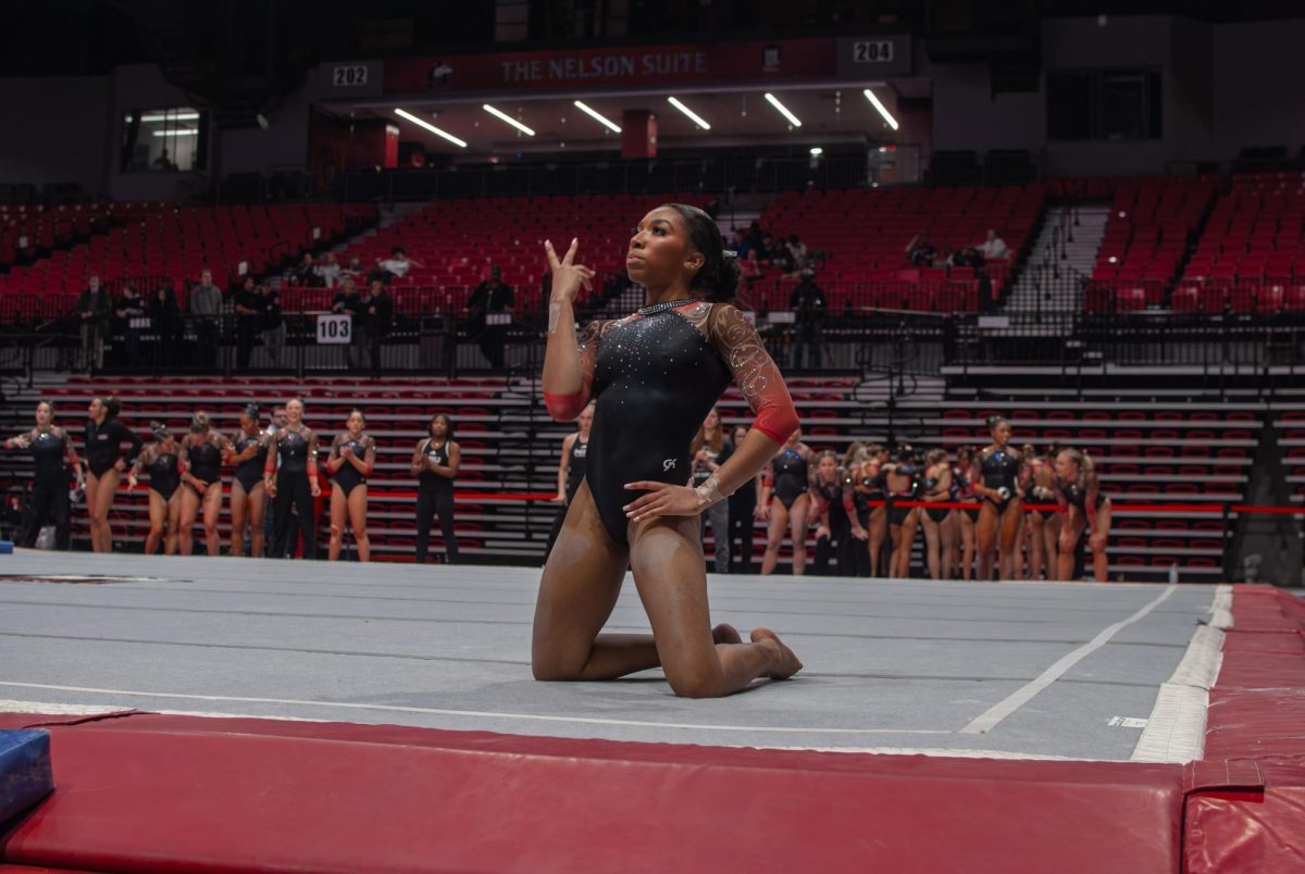 NIU gymnastics sophomore Drake White poses while performing her floor routine on Friday in the Convocation Center. NIU placed second in gymnastics with a total of 191.700 and lost in wrestling to Southern Illinois University Edwardsville 16-15. (Aidan Penca | Northern Star)