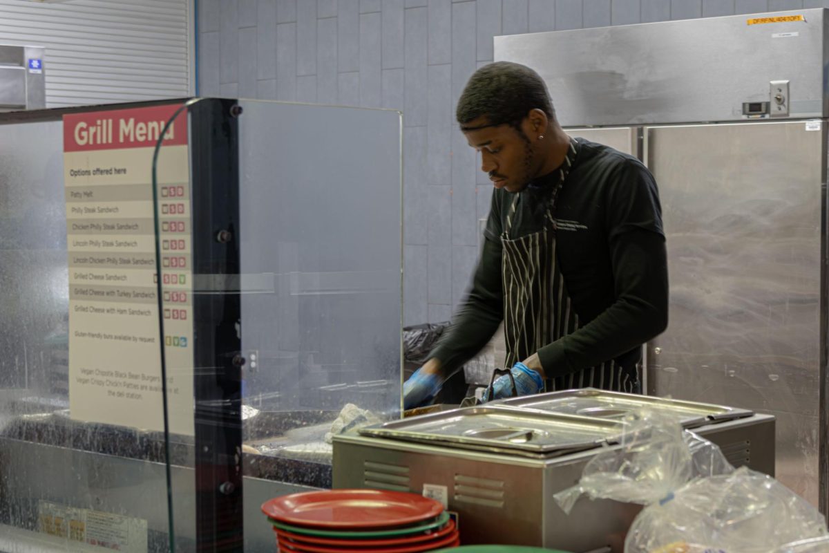Junior early childhood education major and student worker Darrel Wilson prepares a Lincoln Philly Cheesesteak on Monday at Patterson Dining Hall. Some student workers had to work from Jan. 23 until Jan. 25 despite the harsh weather. (Aidan Penca | Northern Star)
