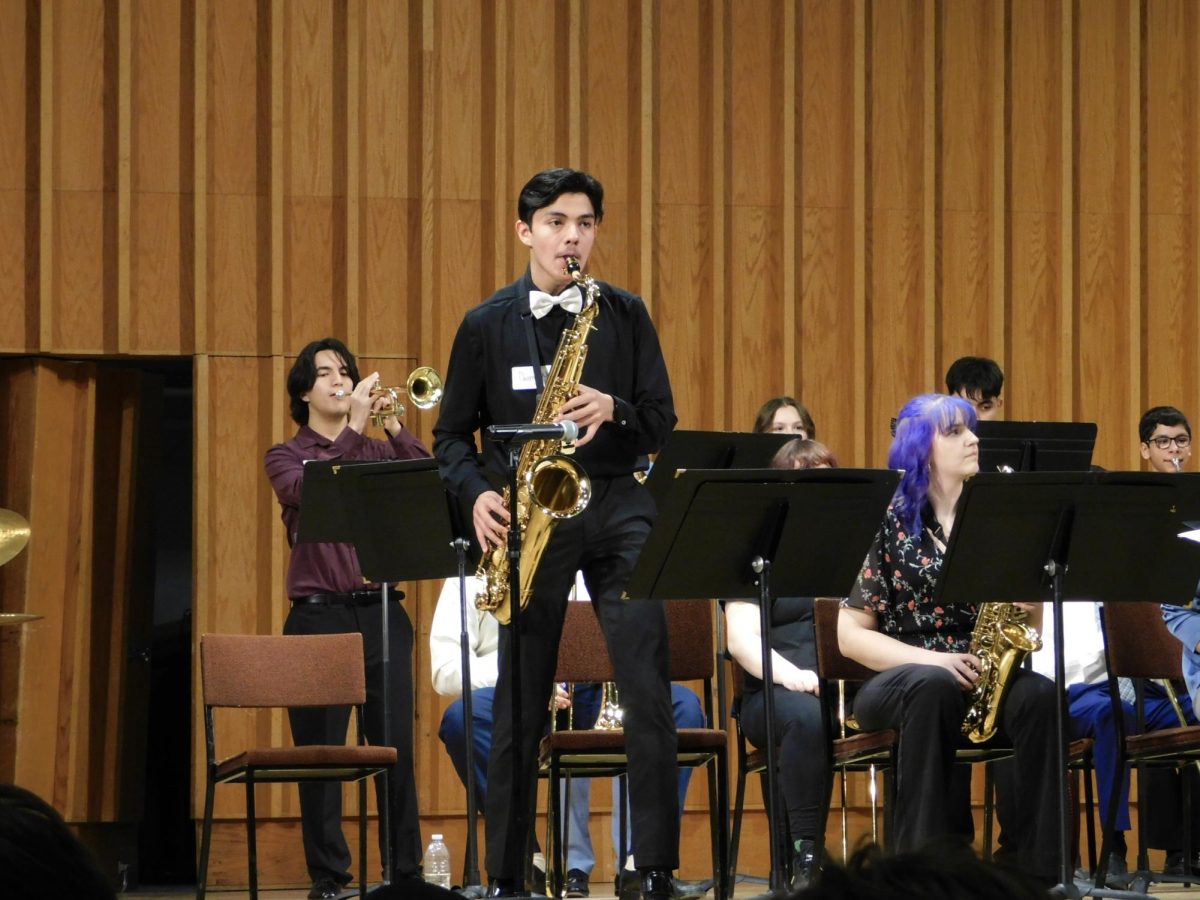 Argo Community High School Jazz Band tenor saxophonist Daniel Nino looks into the audience as he performs his solo in “The Peanut Vendor” by Moises Simons. Nino was featured in two pieces of Argo’s Jazz Day performances with “Doxy” by Sonny Rollins and “The Peanut Vendor.” (Sofia Howell | Northern Star) 